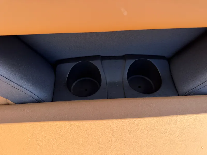 Slide: The Image of Close-up of two cup holders in a boat, surrounded by cushioned seating. - 29