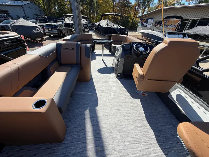 Slide: The Image of The image shows the interior of a 2027 Sylvan Q-20 Party Fish with comfortable seating and a helm. - 17