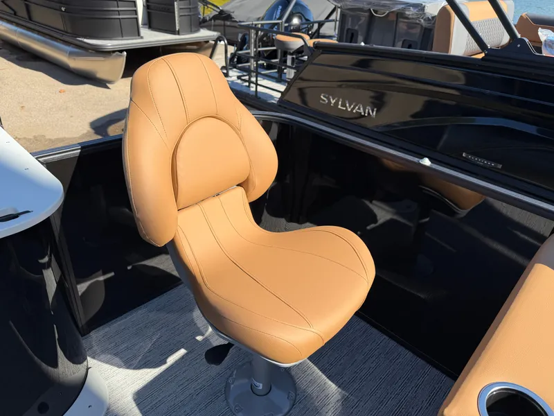 Slide: The Image of A sleek, swivel chair in a Sylvan Q-20 Party Fish boat, surrounded by black interior. - 18