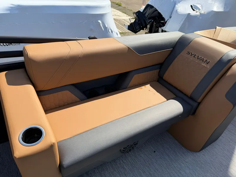 Slide: The Image of The image shows a luxurious, cushioned bench seat in a boat with a cup holder. - 28