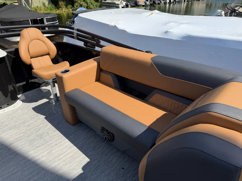 Slide: The Image of The image shows the interior of a Sylvan Q-20 Party Fish boat with comfortable seating. - 27