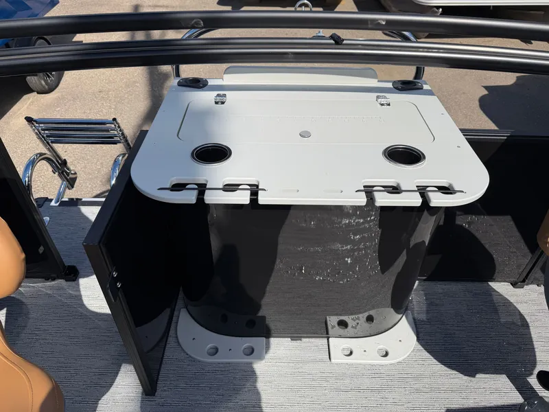 Slide: The Image of The image shows a modern boat table with cup holders and storage space underneath. - 23