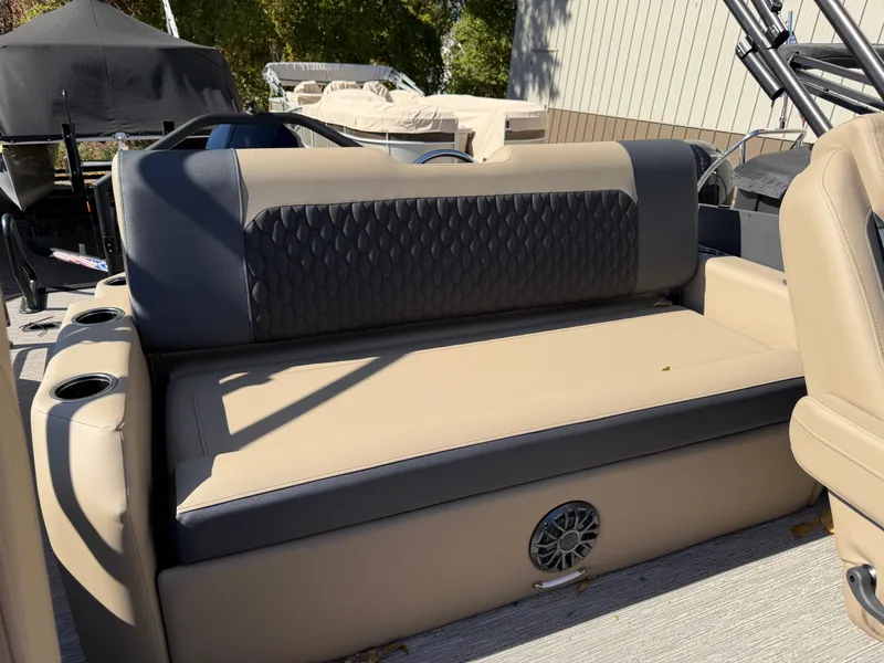 Slide: The Image of The image shows a beige and black bench seat on a boat, surrounded by other boats. - 24