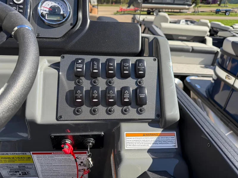 Slide: The Image of Close-up of a Sylvan X3 ULZ boat's control panel with various switches and gauges. - 20