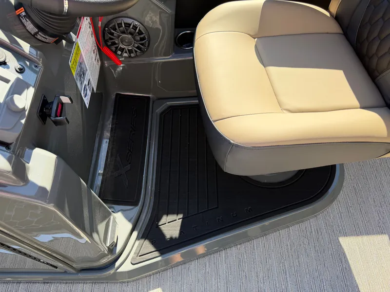 Slide: The Image of Interior of a 2027 Sylvan X3 ULZ boat with beige seating and gray flooring. - 16