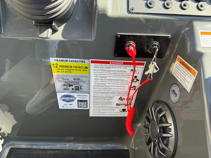 Slide: The Image of The image shows the dashboard of a Sylvan X3 ULZ boat with safety and capacity notices. - 21