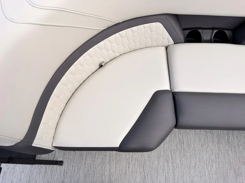 Slide: The Image of Close-up of a sleek, upholstered seat with honeycomb pattern and cup holders on a boat. - 21