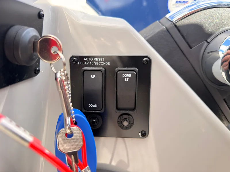 Slide: The Image of Close-up of a boat switch panel with keys. Labels: "Auto Reset" and "Dome LT." - 40