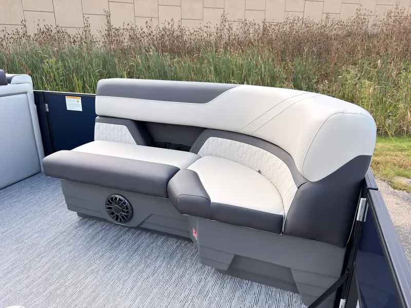 Slide: The Image of The image shows a modern, cushioned bench seat on a boat, surrounded by reeds. - 12