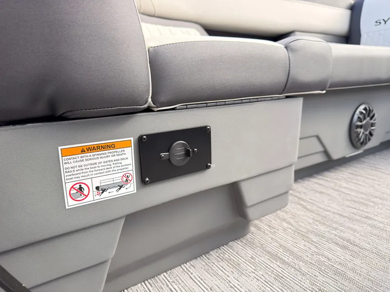 Slide: The Image of The image shows the seating area of a 2027 Sylvan Q-20 Party Fish boat with a warning label. - 13