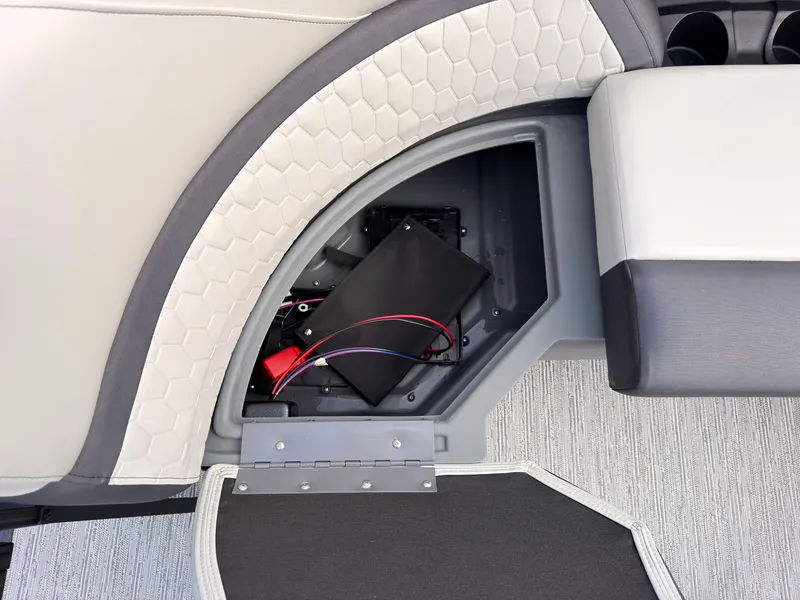 Slide: The Image of An open storage compartment on a Sylvan Q-20 Party Fish boat reveals wires and electronics. - 22