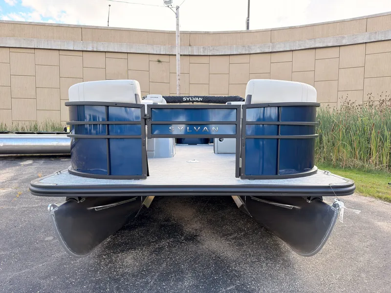 Slide: The Image of A 2027 Sylvan Q-20 Party Fish pontoon boat, blue with gray accents, is parked on a lot. - 7