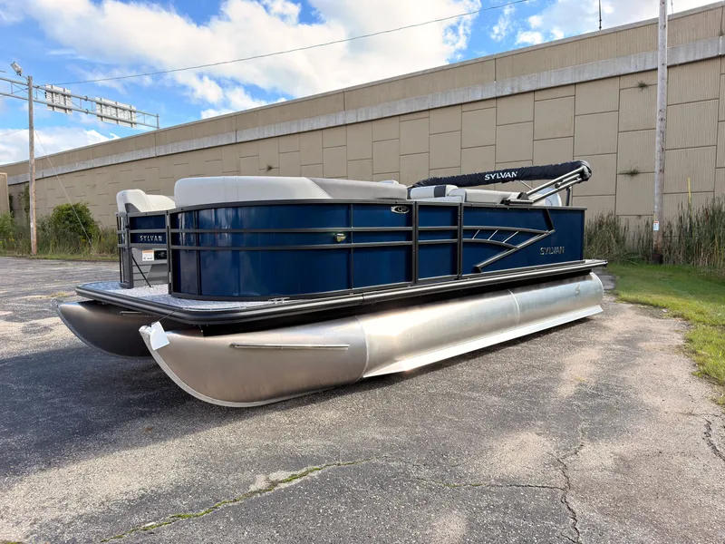 Slide: The Image of A 2027 Sylvan Q-20 Party Fish pontoon boat is parked on a lot in front of a building. - 5