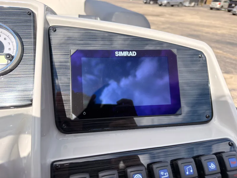 Slide: The Image of The image shows a modern boat cockpit with a Simrad display and various controls. - 36