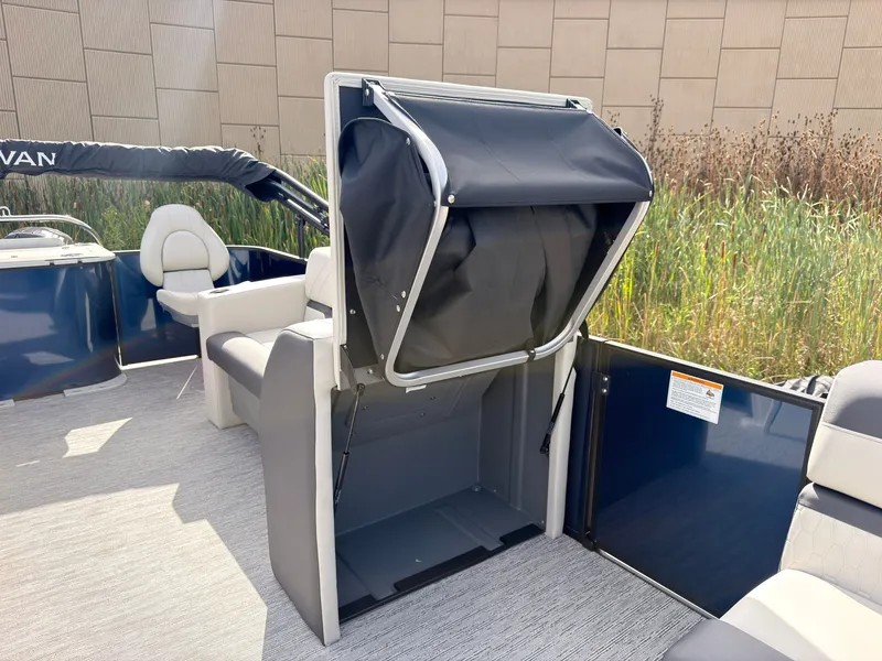 Slide: The Image of The image shows the interior of a 2027 Sylvan Q-20 Party Fish boat with seating. - 29