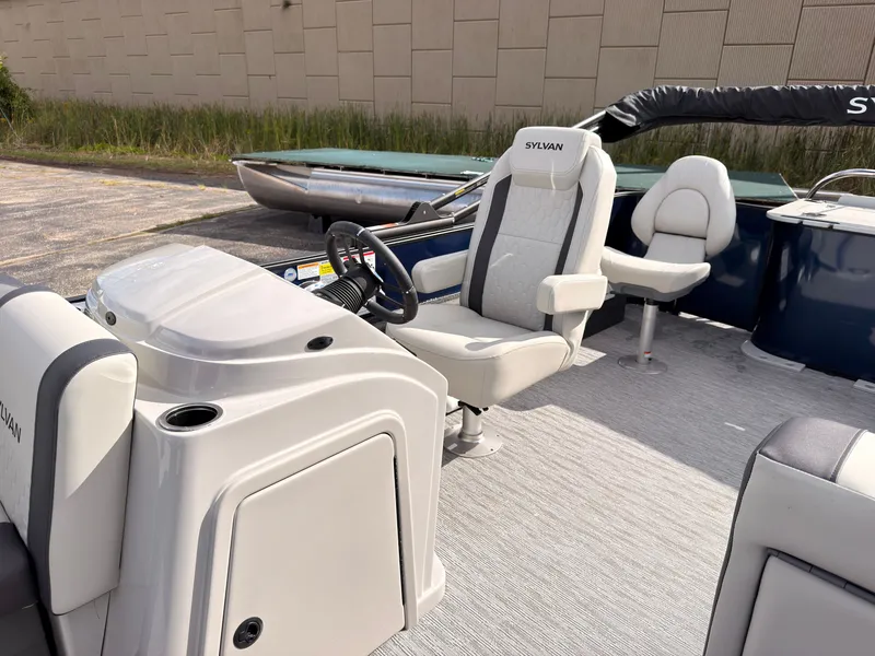 Slide: The Image of The image shows the cockpit of a 2027 Sylvan Q-20 Party Fish boat with comfortable seating. - 31
