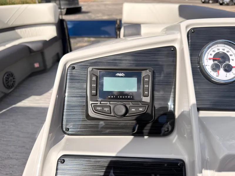 Slide: The Image of The image shows the dashboard of a Sylvan Q-20 Party Fish boat with an audio system. - 34