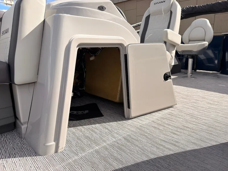 Slide: The Image of The image shows the interior of a 2027 Sylvan Q-20 Party Fish boat with an open storage compartment. - 30