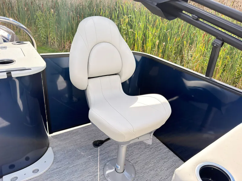 Slide: The Image of A sleek, white captain's chair on a 2027 Sylvan Q-20 Party Fish boat. - 48