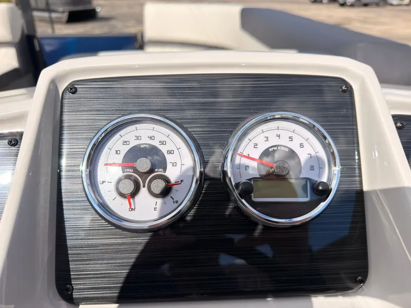 Slide: The Image of Dashboard of the 2027 Sylvan Q-20 Party Fish with speedometer and tachometer. - 35