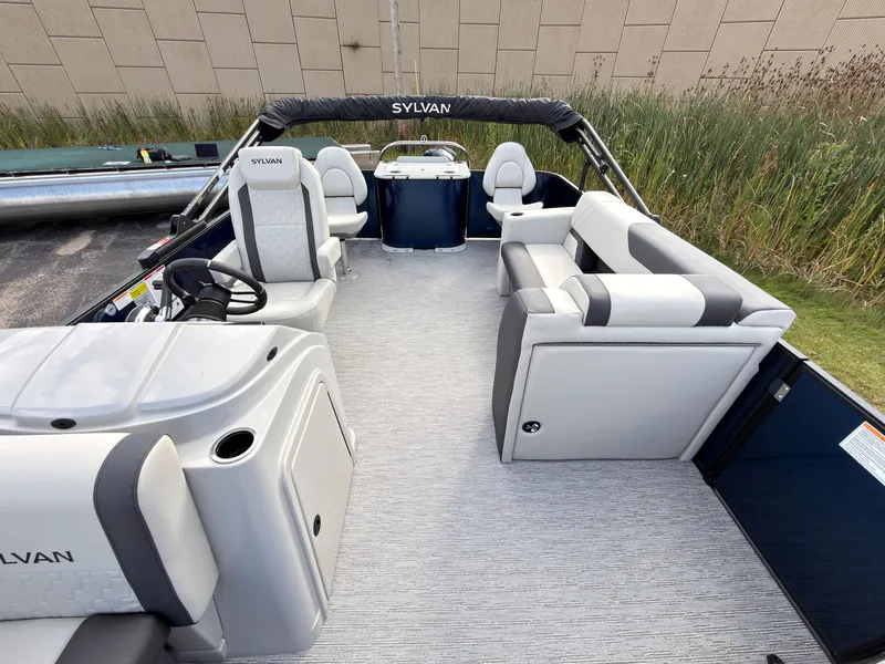 Slide: The Image of The image shows a 2027 Sylvan Q-20 Party Fish boat. It features spacious, cushioned seating and a modern helm. - 26