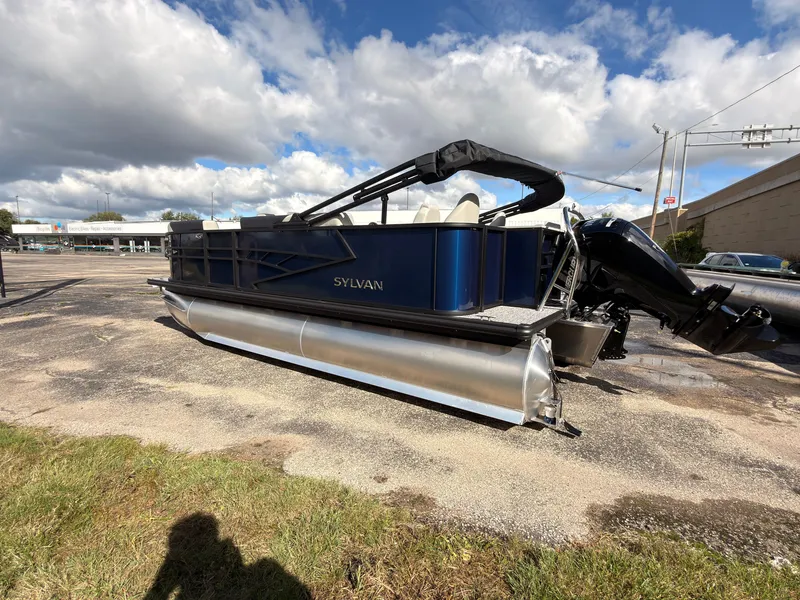 Slide: The Image of The image shows a 2027 Sylvan Q-20 Party Fish pontoon boat in a parking lot. - 3