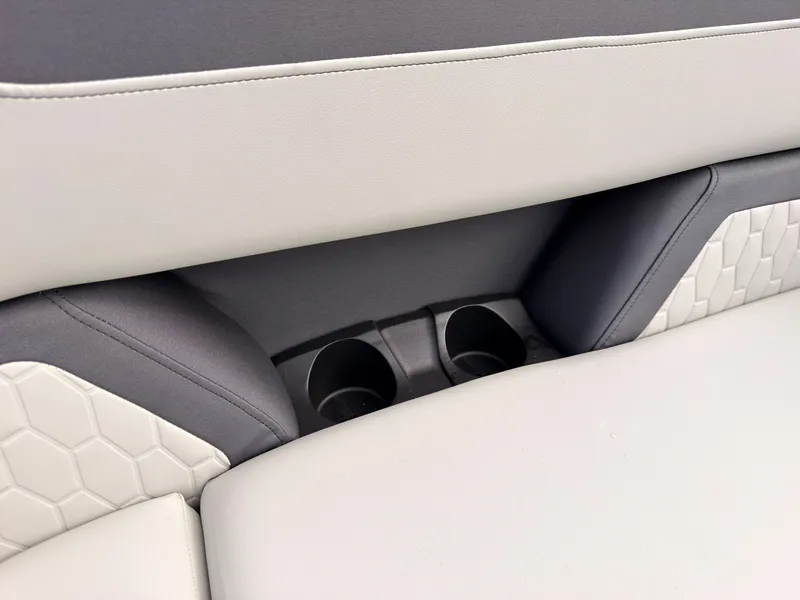 Slide: The Image of Close-up of a boat seat with two cup holders and cushioned design. - 25