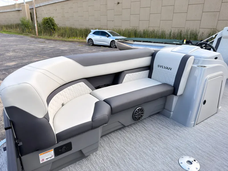 Slide: The Image of The image shows the stylish interior of a Sylvan Q-20 Party Fish boat with gray and white seating. - 11