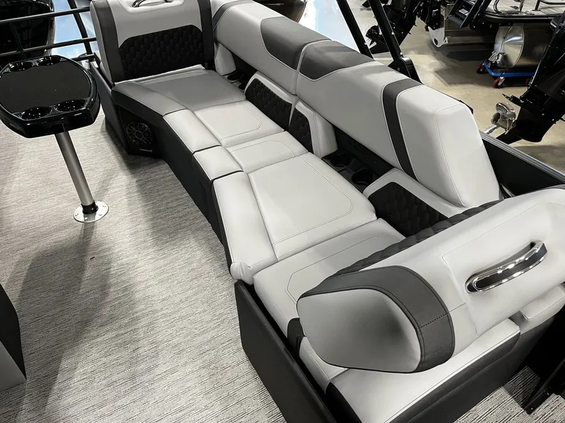 Slide: The Image of Interior of the 2027 Sylvan X3 SLZ with sleek gray and black upholstery and a small table. - 17