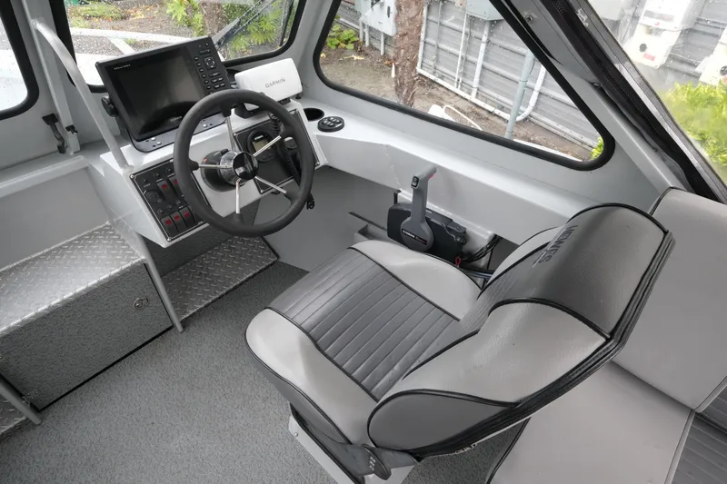 Slide: The Image of Interior of a 2016 Hewescraft 210 Sea Runner ET Hardtop with steering wheel and controls. - 13