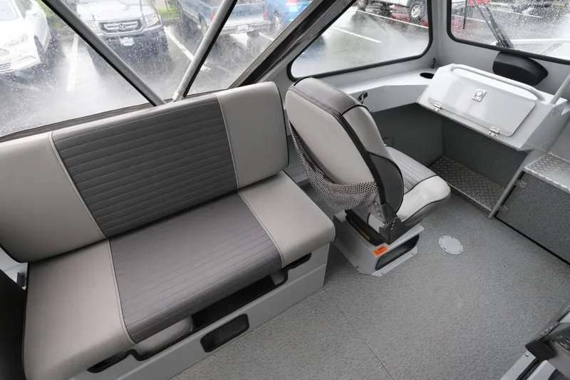 Slide: The Image of Interior of 2016 Hewescraft 210 Sea Runner ET Hardtop, featuring seating and storage. - 11