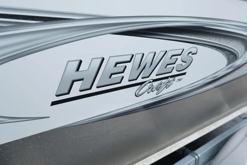 Slide: The Image of Close-up of 2016 Hewescraft 210 Sea Runner ET Hardtop logo on boat exterior. - 7