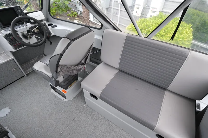 Slide: The Image of 2016 Hewescraft 210 Sea Runner ET Hardtop interior with steering wheel and seating. - 12