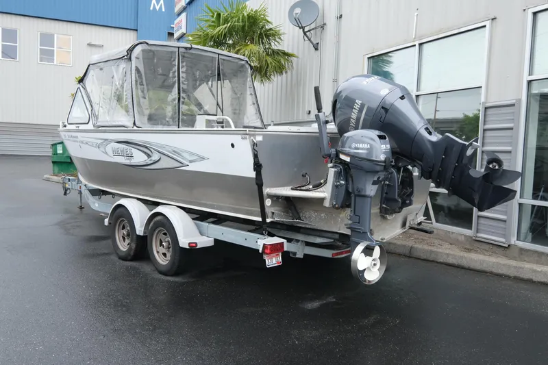 Slide: The Image of 2016 Hewescraft 210 Sea Runner ET Hardtop boat on trailer, parked outdoors. - 4