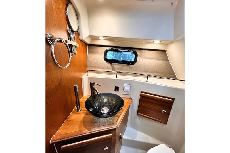 Slide: The Image of Luxurious 2022 Ranger Tugs R-27 bathroom with modern sink and elegant wood accents. - 10