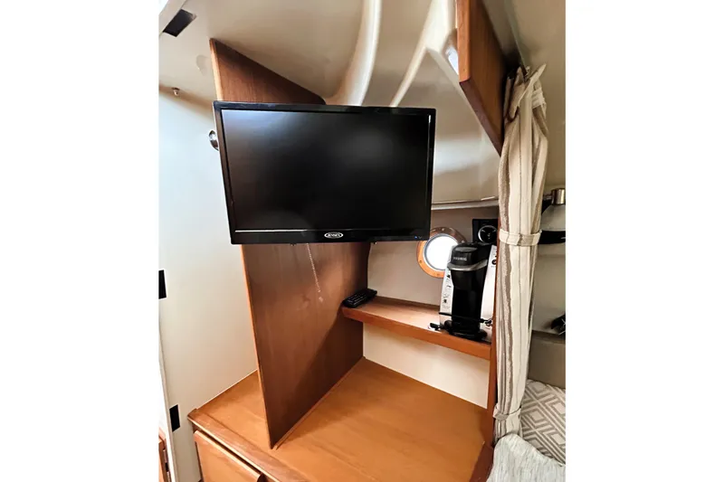 Slide: The Image of Interior of 2022 Ranger Tugs R-27 with TV and coffee maker setup. - 13