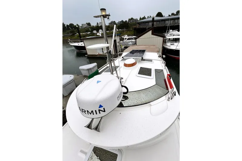 Slide: The Image of 2022 Ranger Tugs R-27 boat with Garmin radar, docked in a marina. - 1