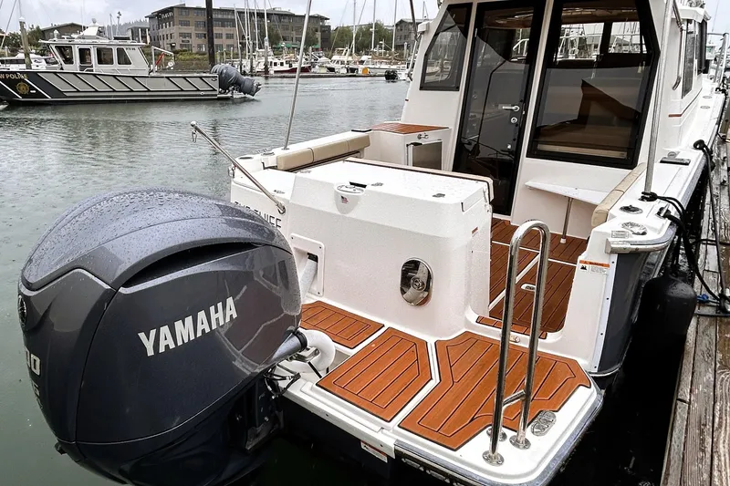 The Image of 2022 Ranger Tugs R-27 boat with Yamaha engine docked in a marina. - 0
