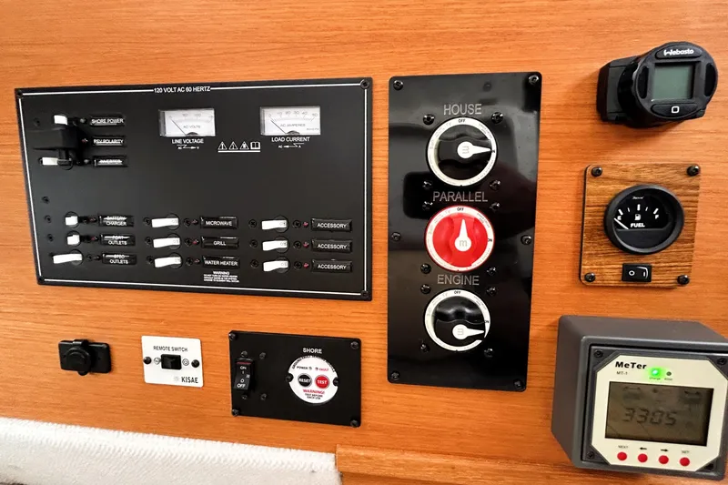 Slide: The Image of Electrical control panel of a 2022 Ranger Tugs R-27 boat with various switches and gauges. - 15