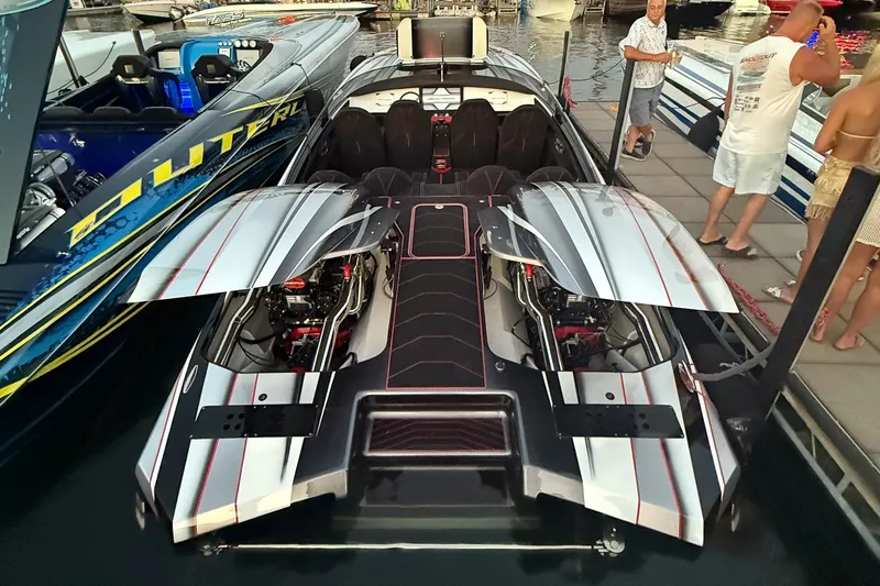 Slide: The Image of High-performance Skater 368 speedboat, 2020 model, docked with open engine compartments. - 12