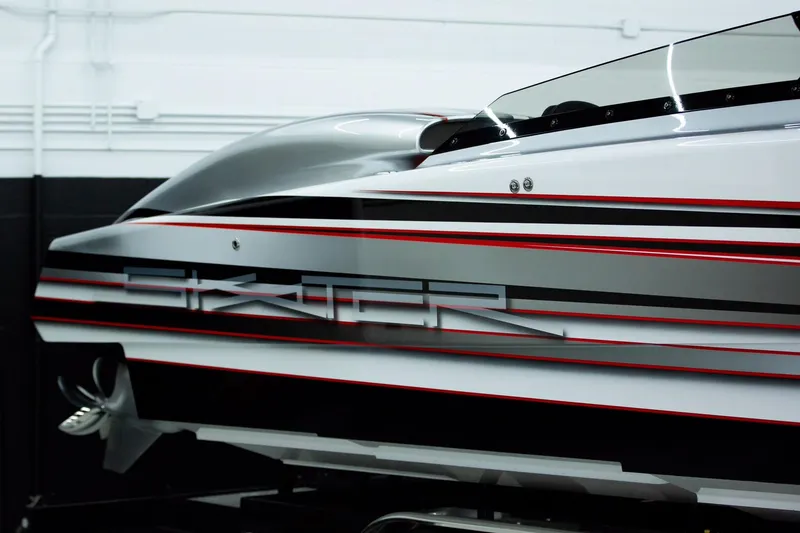 Slide: The Image of 2020 Skater 368 boat with sleek design and red accents in a showroom. - 6