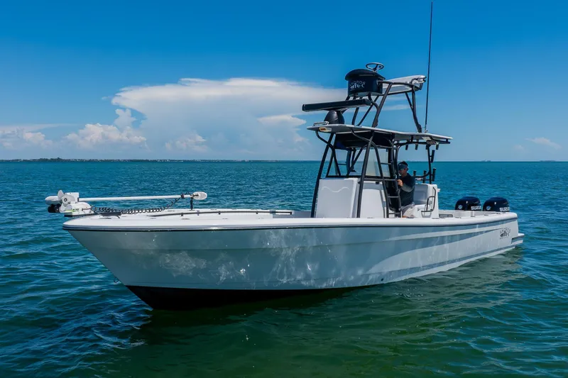 Slide: The Image of 2016 Andros 32 Offshore boat on calm blue water under clear sky. - 8
