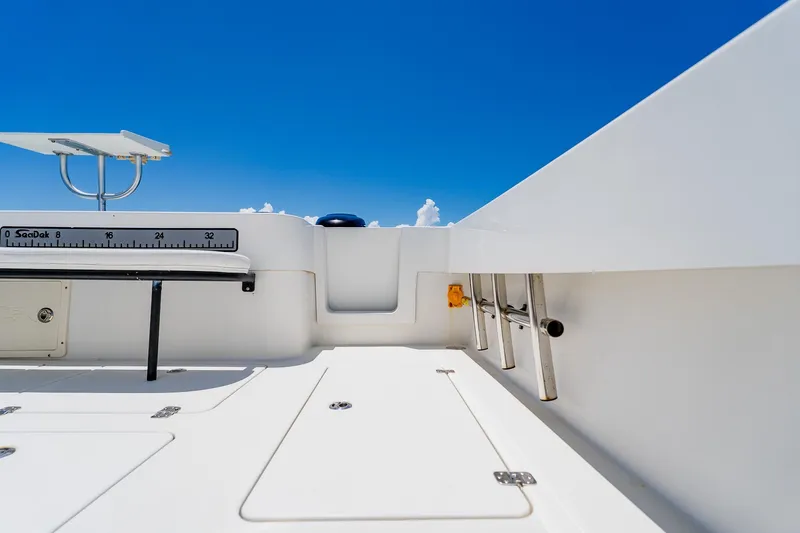 Slide: The Image of 2016 Andros 32 Offshore boat deck with ladder and clear blue sky. - 64