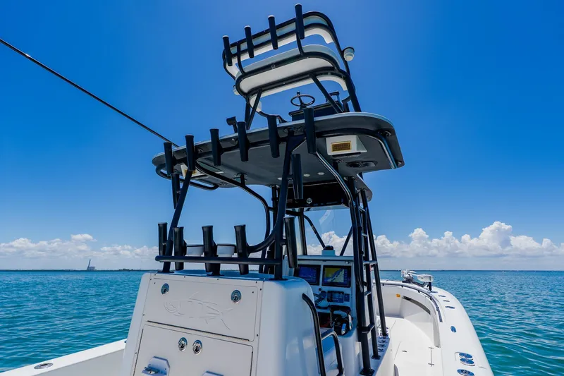 Slide: The Image of 2016 Andros 32 Offshore boat on open water under clear blue sky. - 59