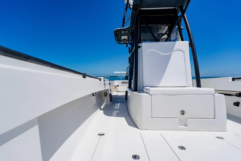 Slide: The Image of 2016 Andros 32 Offshore boat deck with seating, under clear blue sky. - 34
