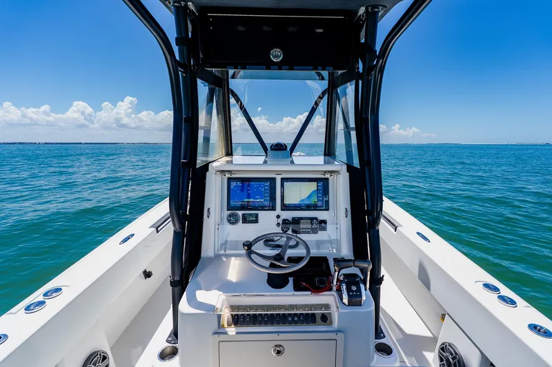 Slide: The Image of 2016 Andros 32 Offshore boat dashboard with navigation screens on open sea. - 45