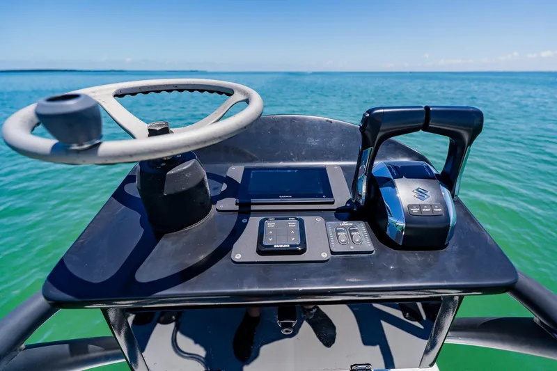 Slide: The Image of Helm of 2016 Andros 32 Offshore boat with steering wheel and controls on open water. - 86