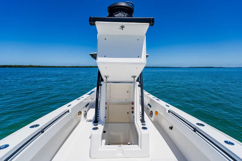 Slide: The Image of 2016 Andros 32 Offshore boat on clear blue water, showcasing open storage compartment. - 36