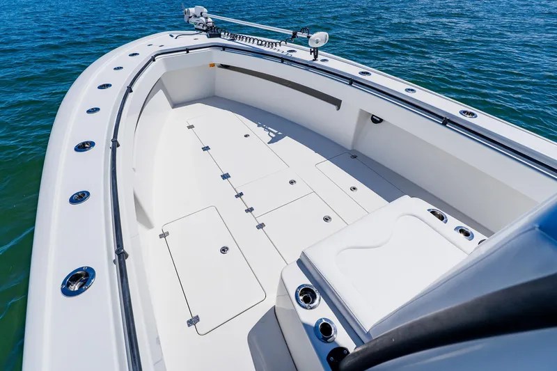 Slide: The Image of 2016 Andros 32 Offshore boat deck with storage compartments on calm water. - 21