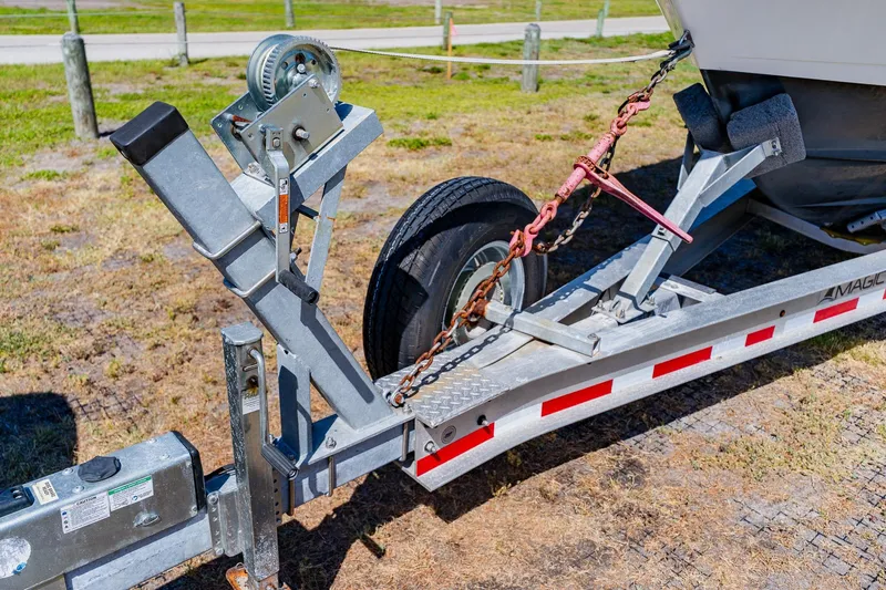 Slide: The Image of Trailer hitch of 2016 Andros 32 Offshore boat on grassy area. - 94